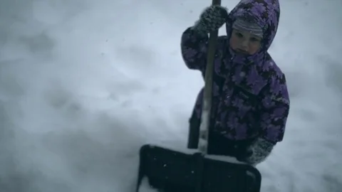 A child with a shovel in the winter. Stock Footage 80232206