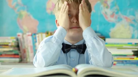 The child shows different emotions in the classroom. Stock Footage
