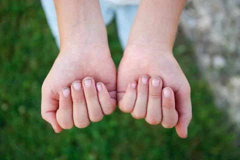 The child shows nails in the mud. Stock Photos