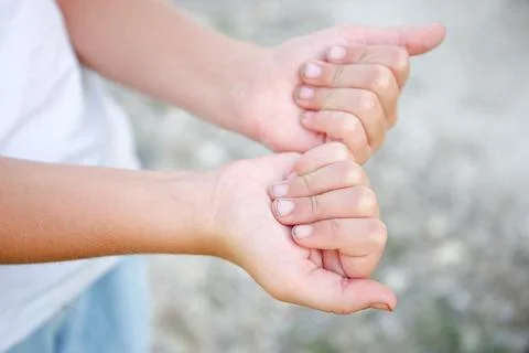The child shows nails in the mud. Stock Photos