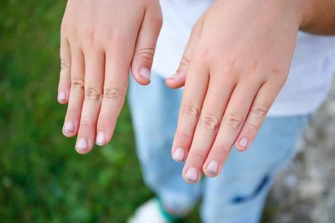 The child shows nails in the mud. Stock Photos