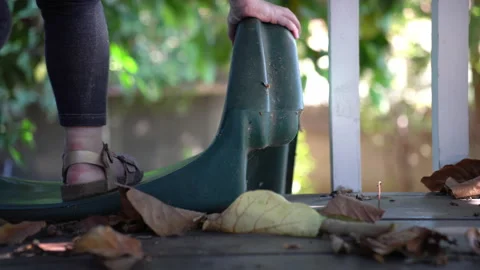 Child sits down on treehouse slide and looks out Stock Footage 140159040