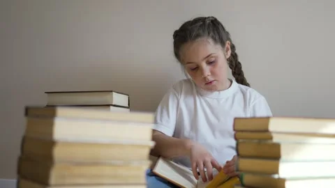 Child sits on floor of library and reads book. Smart generation reads books Stock Footage 252109307