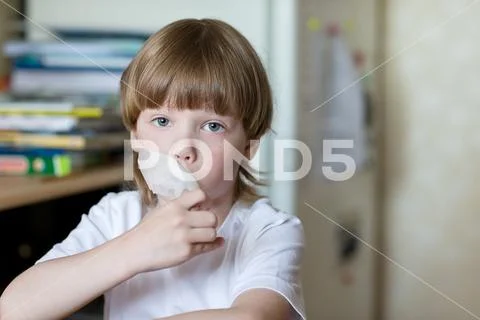 Child sits with mouth sealed tape Stock Photos