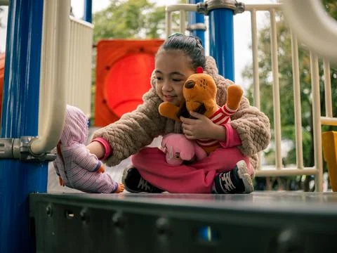 Child sits on a playground platform Foto stock