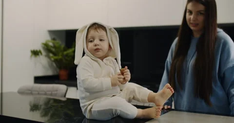 A child sits at the table and eats cookies Stock Footage 150641847