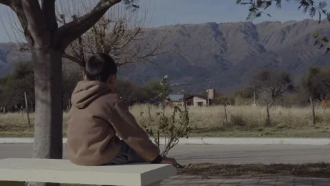 Child Sitting on Bench Watching Mountain Landscape Rural Scene Stock Footage 314025550