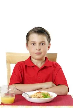 Child sitting at dinner table Stock Photos