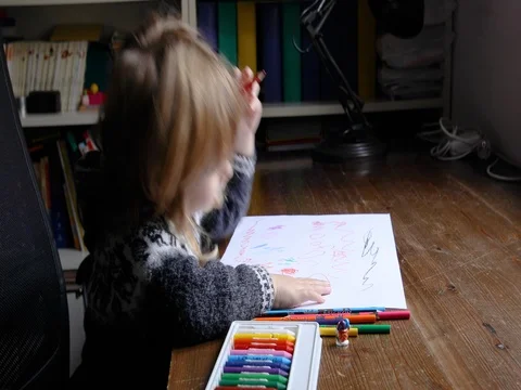 Child sitting drawing white sheets Stock Footage 71411429