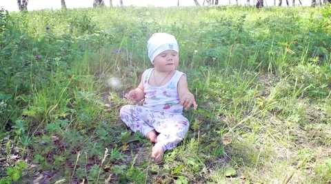 Child sitting on the grass Video stock 54581851
