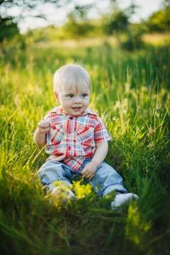 Child sitting on the grass Stock Photos