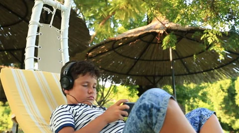 Child sitting on hammock with smartphone 2 Stock Footage 67756735