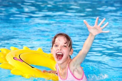 Child sitting on inflatable ring thumb up. Foto stock