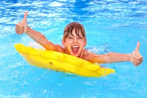 Child sitting on inflatable ring thumb up. 스톡 사진