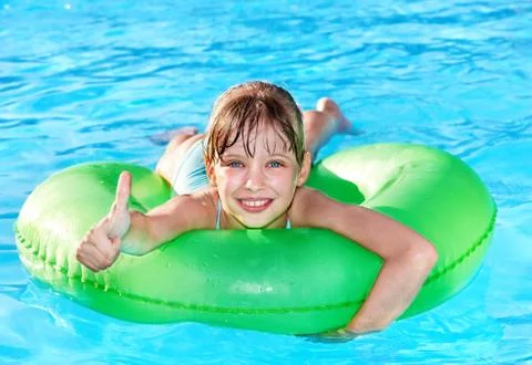 Child sitting on inflatable ring thumb up. 스톡 사진
