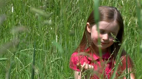 Child sitting in meadow Stock Footage 22664020