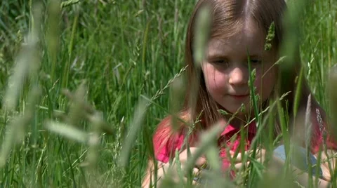 Child sitting in meadow Stock Footage 22664023
