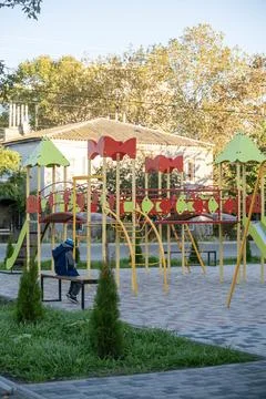 A child is sitting on the playground Stock Photos