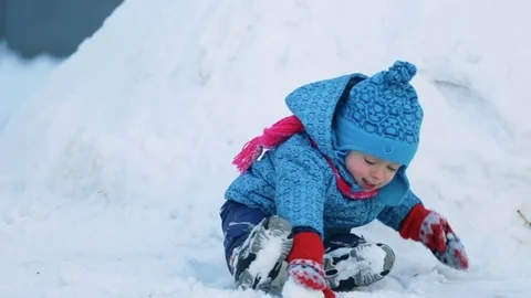 Child sitting in the snow Stock Footage 71949542