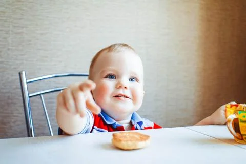 The child is sitting at the table Stock Photos