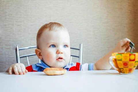 The child is sitting at the table Stock Photos