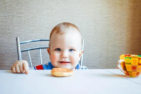 The child is sitting at the table Stockfoto's
