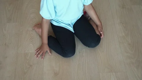 Child sitting W posture on the floor . Stock Footage 260681008