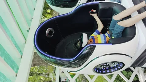 A child is sitting in a white car with a virtual reality headset on Stock-Footage 282899576
