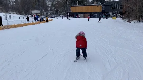 Child Skiing Downhill in Winter While Snow is Falling 動画素材 124441927