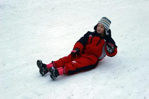 Child sledding on snow Foto stock