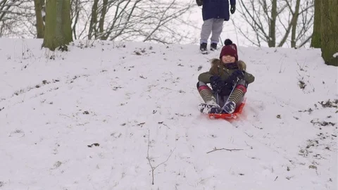 Child sledging down a hill Stock Footage 86748525