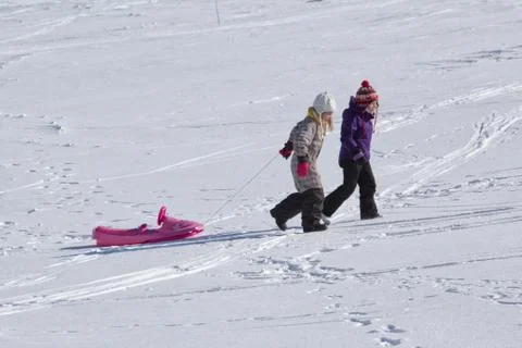 Child sledging on high mountain Stock Photos