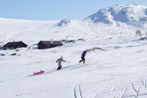 Child sledging on high mountain Stock Photos