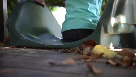 Child slides down green slide in treehouse Stock Footage 140209319