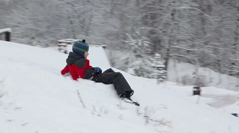 The child slides from an ice slope Stock Footage 48666413