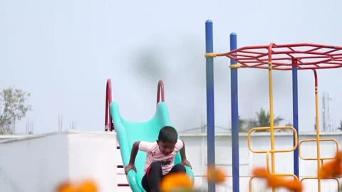 Child Sliding Down Playground Slide at Public Park in Dibrugarh Stock Footage 334774341
