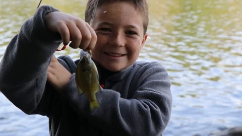 Child with small fish on the line. Stock-Footage 115343483