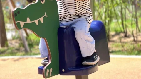 A child on a small ride in a playground Video stock 243100582