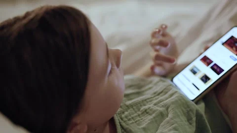 Child with smartphone before bedtime.	 Stock Footage 311805324