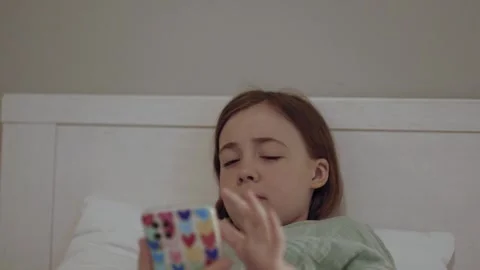 Child with smartphone before bedtime.	 Stock Footage 311806465