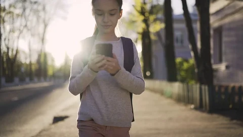 Child with smartphone at sunset Stock Footage 75700550