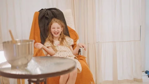Child smiles brightly while preparing pumpkin pie. Cheerful girl Stock Footage 346395268