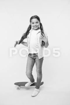 Child smiling face stand on skateboard. Penny board cute colorful skateboard for Stock Photos