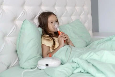 A child smiling while receiving asthma or cold treatment Stock Photos