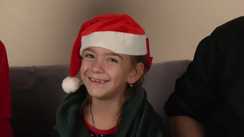 The child is smiling while wearing a Santa hat Stock Footage 319829422