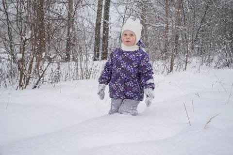 Child in the snow in the forest Stock Photos
