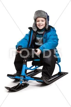 Child on snow scooter or snowmobile toy Stock Photos