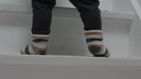 Child in Socks Climbing Up the Stairs Stock Footage 303499501