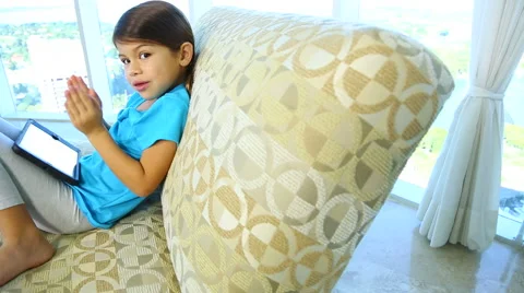 Child on sofa with her tablet Video stock 46295769