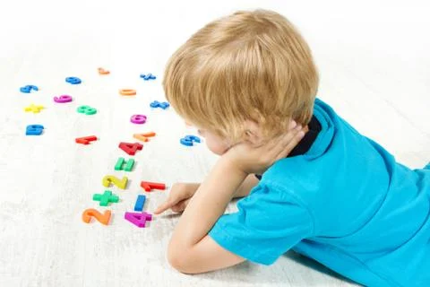 Child solve the mathematics example. Kid Looking for answer. Stock Photos